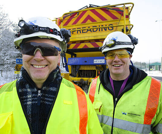 Workers in front of gritter