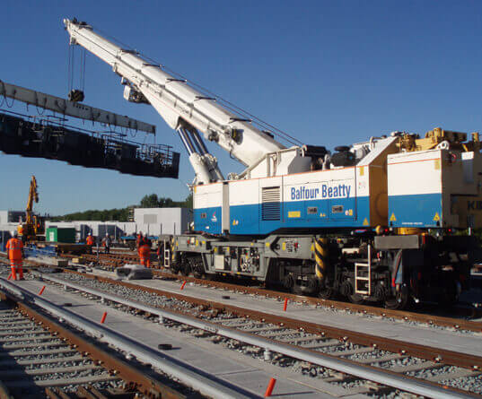 a rail mounted heavy lifting crane lifting in a gantry