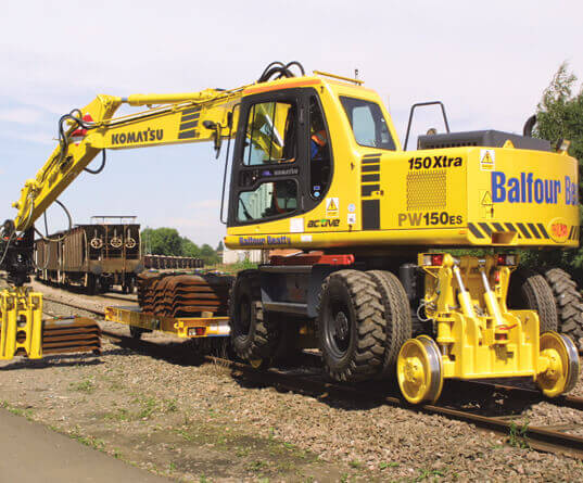 a road rail vehicle lifting some sleepers