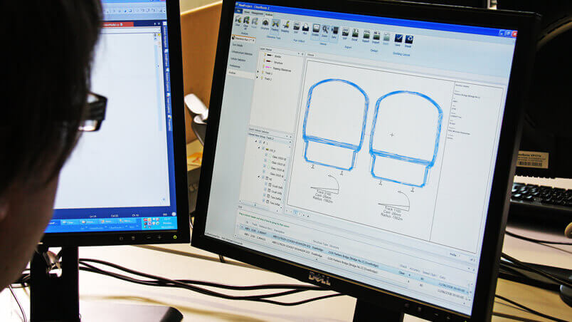 Person looking at a monitor showing specialist gauging software in use
