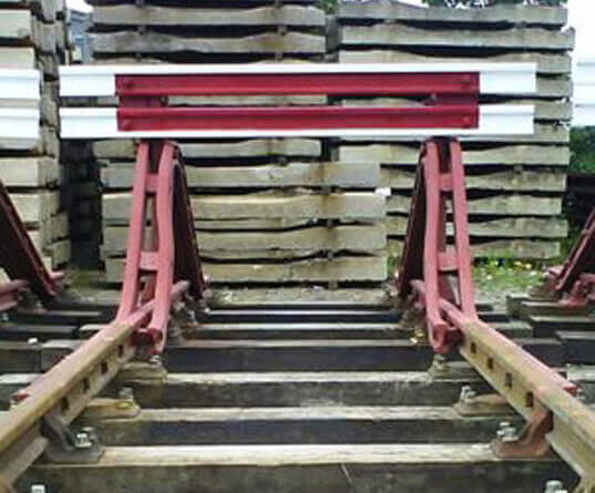 train buffer stop and pile of railway sleepers