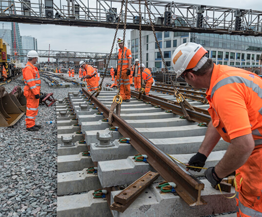 Rail workers installing new track