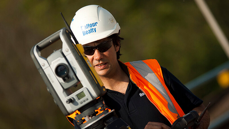 Person operating surveying equipment